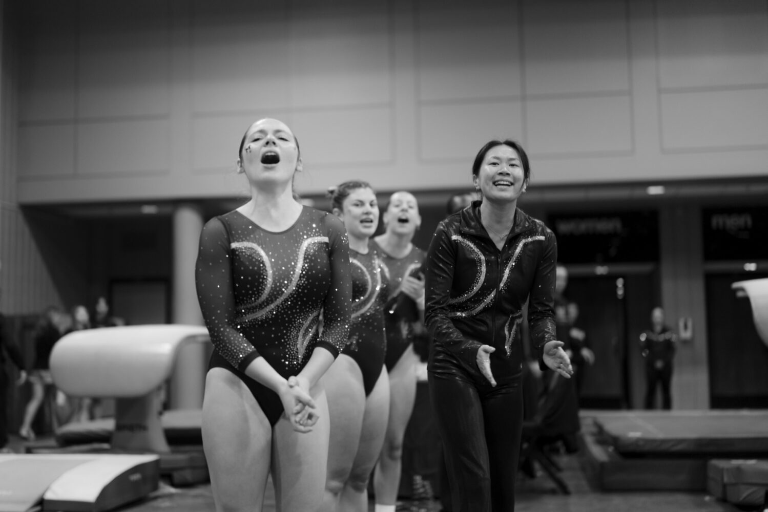 Teammates cheer from the sidelines at a UCG meet