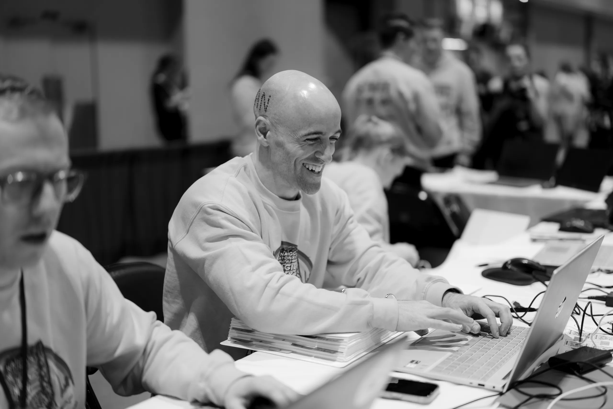 Volunteers working at laptops during the 2026 gymnastics Nationals